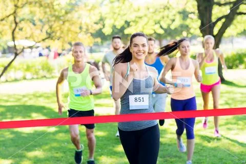 Happy young female runner on finish winning race Stock Photos