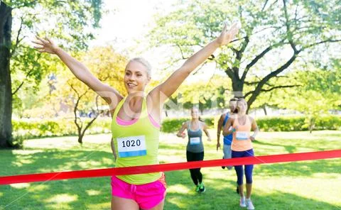 Happy young female runner on finish winning race Stock Photos