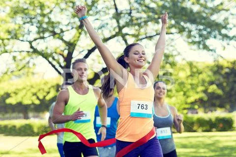 Happy young female runner winning on race finish Stock Photos
