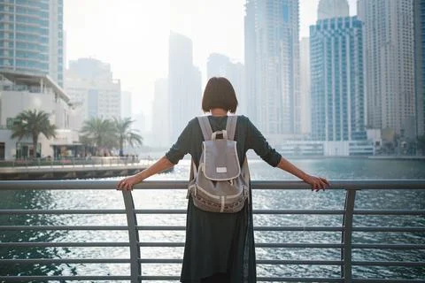 Happy young female traveler in the big city of Dubai, UAE Stock Photos