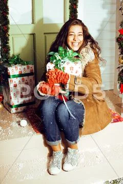 Happy Young Girl At Home Decorated On Christmas, Bringing Gifts To Friends