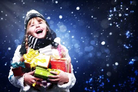 Happy young girl with many christmas gifts, abstract art backgrounds Stock Photos
