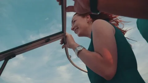Happy young girl in turquoise dress drive motor boat with man. Romantic couple Stock Footage