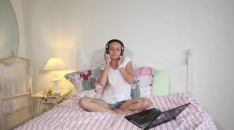 Happy young girl watching a movie on laptop at home Stock Footage