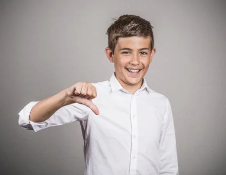 Happy young guy giving thumbs down gesture Stock Photos