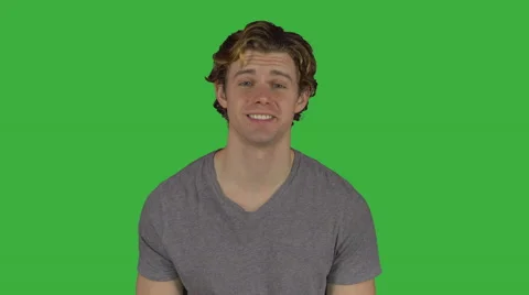 Happy young guy looking all around him (Green Key) Stock Footage 64948475