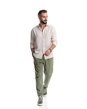 Happy young guy looking to side, smiling and stepping forward Stock Photos