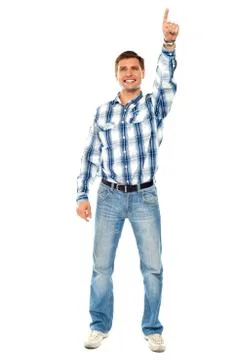Happy young guy pointing upwards. Full shot Stock Photos