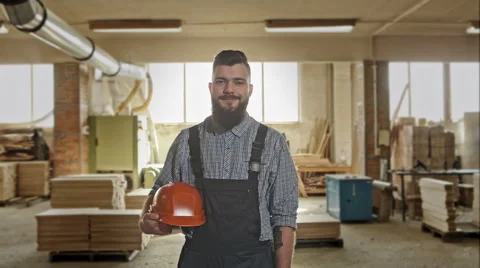 Happy young handyman carpenter in workshop, smiling. RAW video record Stock Footage 61093913