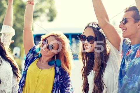 Happy young hippie friends dancing outdoors Stock Photos