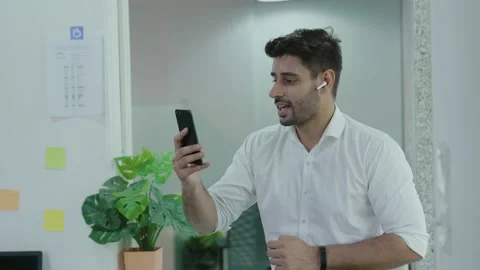 Happy young indian man making a video call smiling and talking. Stock Footage 168218863
