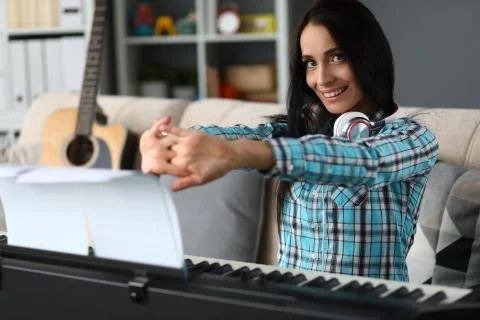 Happy young lady resting while flexing fingers Stock Photos