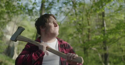Happy young Lumberjack in forest with axe Stock Footage 148164033