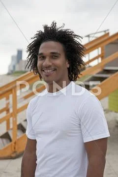 A happy young man at the beach, waist up Stock Photos