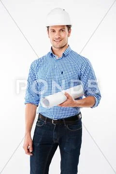 Happy young man building engineer in helmet holding blueprint Stock Photos