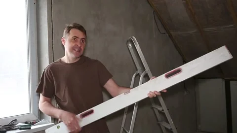 Happy young man dancing and sings together with work tools during apartment Stock Footage 267100374