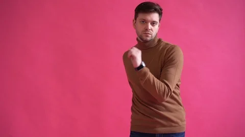 Happy young man dancing in studio isolated over pink background Stock Footage 123916292