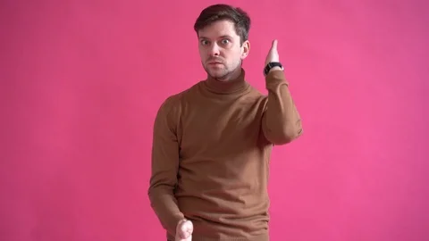 Happy young man dancing in studio isolated over pink background Stock Footage 123916305