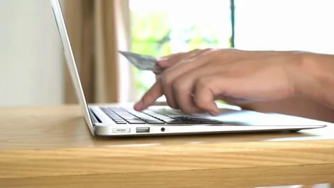 Happy young man doing payments online or shopping in internet store Handsome Stock Footage 265928221