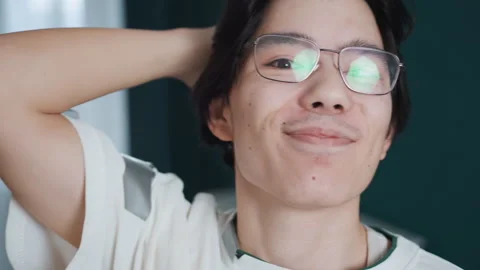 Happy young man expressing triumph at home. Enthusiastic Asian male showing Stock Footage 345530346
