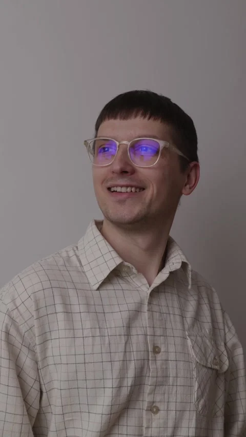 Happy young man with glasses looking away with hopeful smile Stock-Footage 335082341
