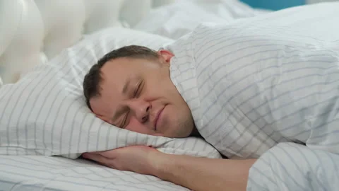 Happy young man goes to bed Stock Footage 150686236