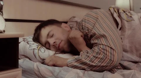 Happy young man going to bed with pleasure Stock-Footage 68421230