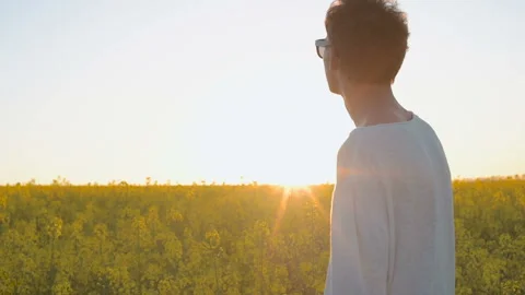 Happy young man having fun and dancing in yellow field during sunset Stock Footage 89443976