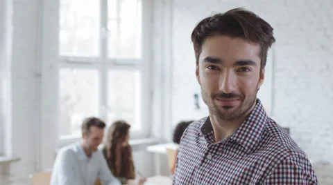 Happy young man looking at camera in the office Stock Footage 64625984