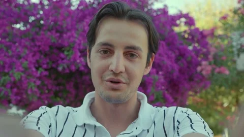 Happy young man looking at camera and chatting with his loved one. Stock Footage 166161019