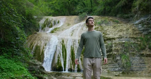 Happy young man, looks and sees a wonderful place Stock Footage