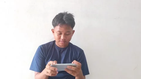 Happy Young Man Playing Mobile Game Indoors Stock Footage 317031538