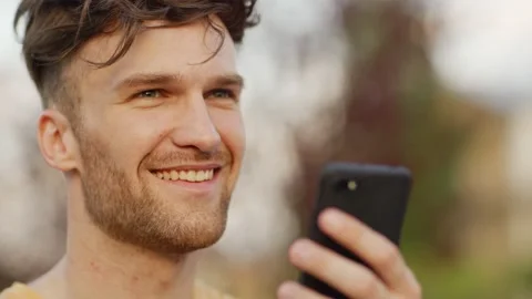 Happy young man reading sms on cell phone Video stock 132726570