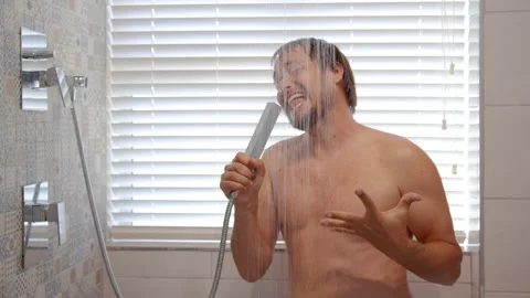 Happy young man singing taking morning shower. Smiling bearded muscular man Stock Footage 150950746