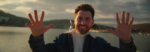 Happy young man smiling feel wonder gestures look around. In the background Stock Footage 252139633