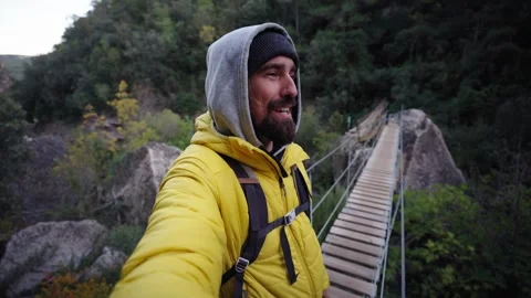 Happy young man smiling looking at camera and landscape standing on wooden Stock Footage 274493273