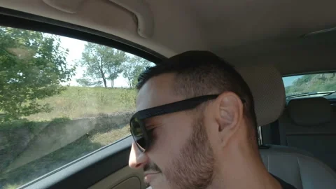 Happy young man with sunglasses dancing in car Stock Footage 144176307