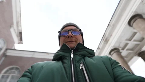 Happy young man taking a selfie portrait in the courtyard of a beautiful Stock Footage 146875494