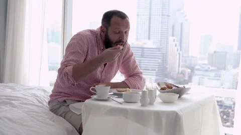 Happy, young man talking to camera during breakfast at home, 4K Stock Footage 92619726