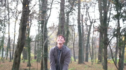 Happy young man throwing leaves in the air Stock Footage 59553886