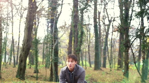 Happy young man throwing leaves in the air Stock Footage 59553903