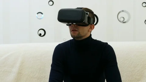 Happy young man use VR headset at homr and looking around Stock Footage
