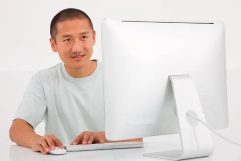 Happy young man using computer Foto stock