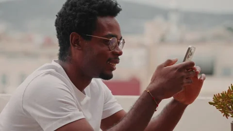 Happy Young Man Using Mobile Phone On Balcony Stock Footage 338340548