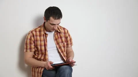 Happy young man using a pad Stock Footage 60064288