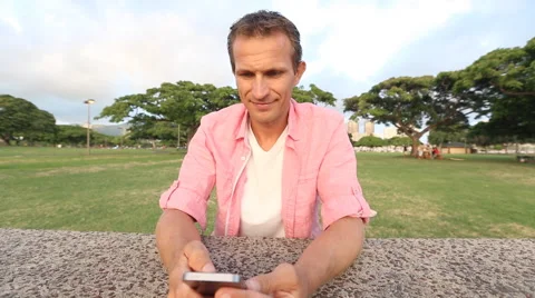Happy Young Man Using Smartphone In Park Stock Footage 55626651