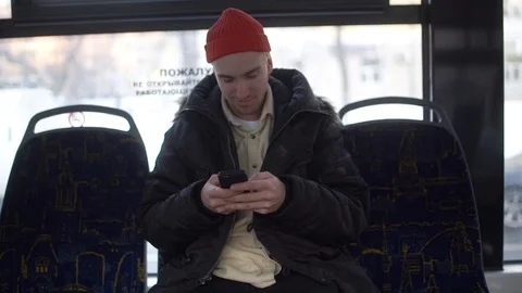 Happy, young man using smartphone during train ride Stock Footage 101748685