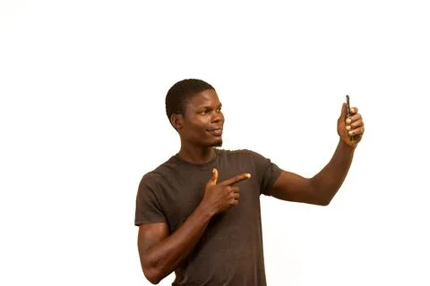 Happy Young Man Using Smartphone and Pointing Up Foto stock