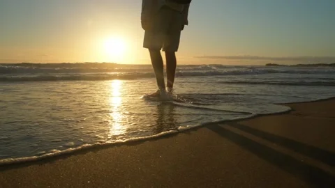 Happy young man walking into a sandy ocean beach on a sunny summer day. You.. Stock Footage 253271767