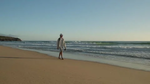 Happy young man walking on a sandy ocean beach on a sunny summer day. Young.. Stock Footage 307158527
